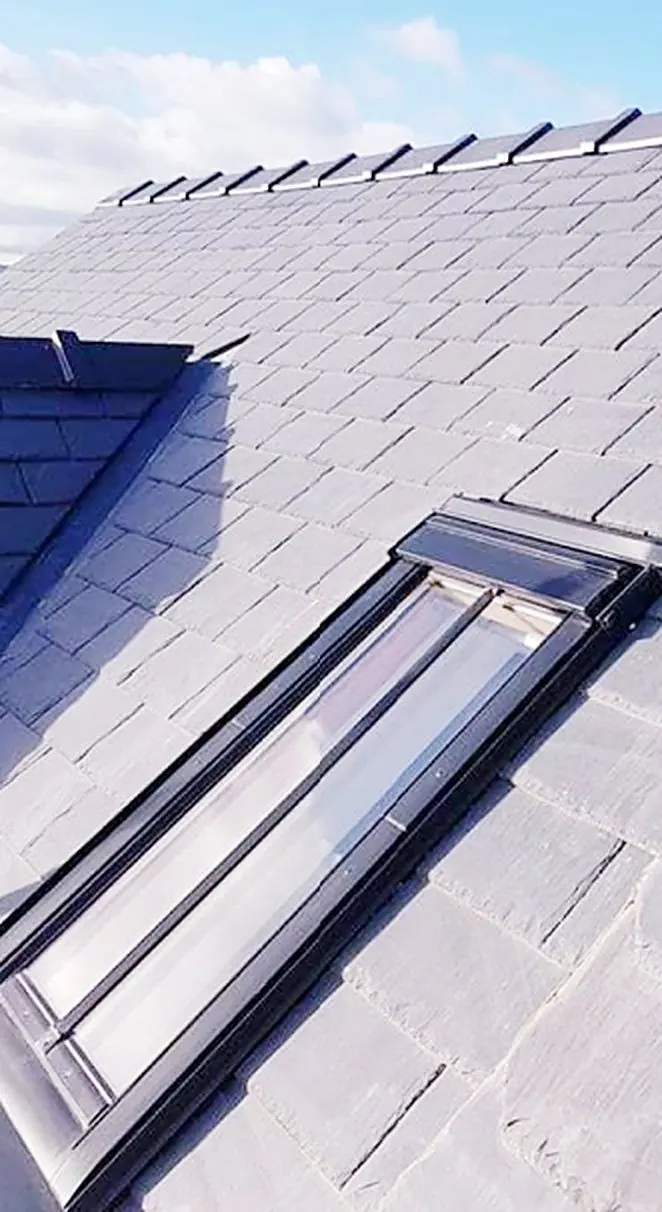 Slate roof with a roof window
