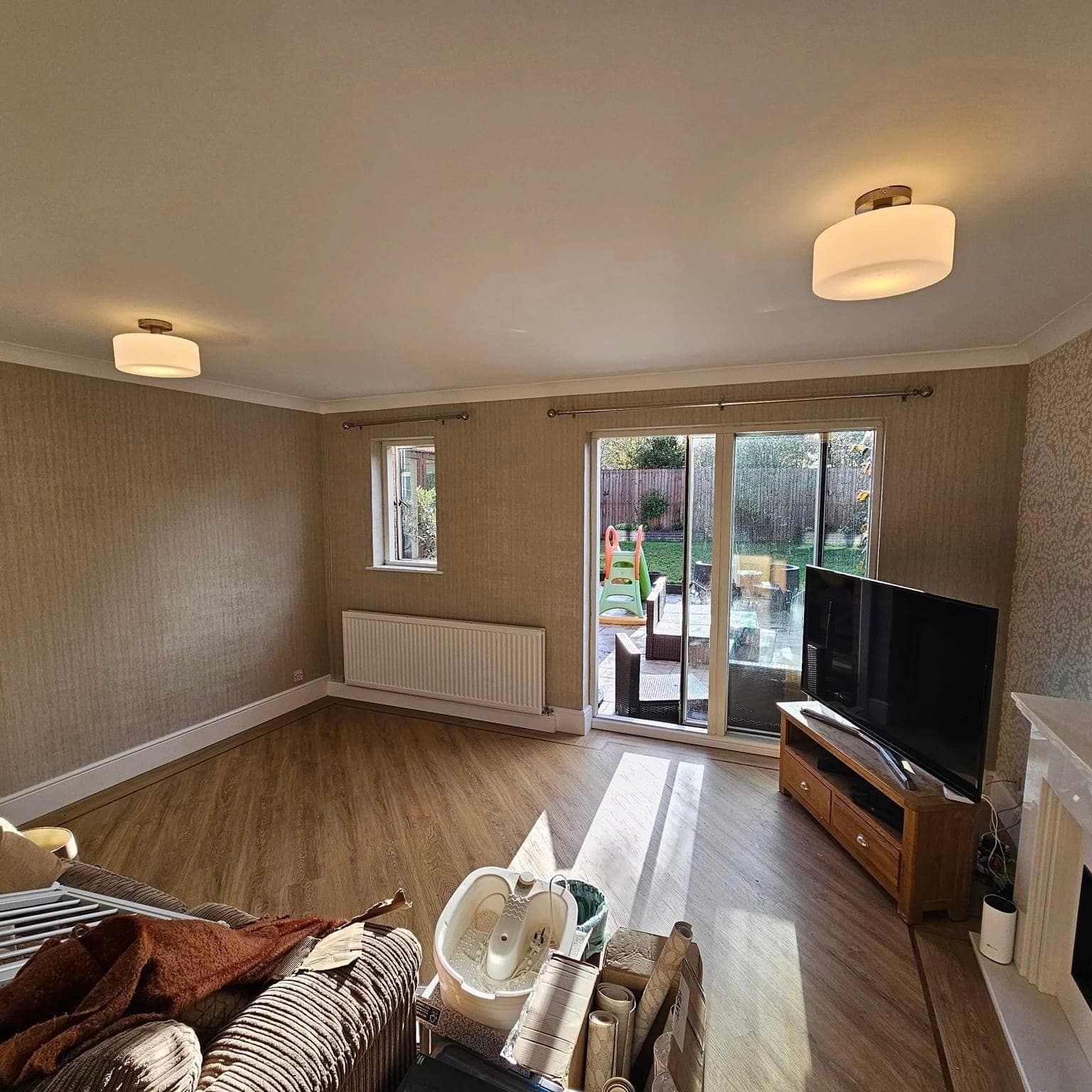 The textured-paper lounge looking towards French doors and the garden