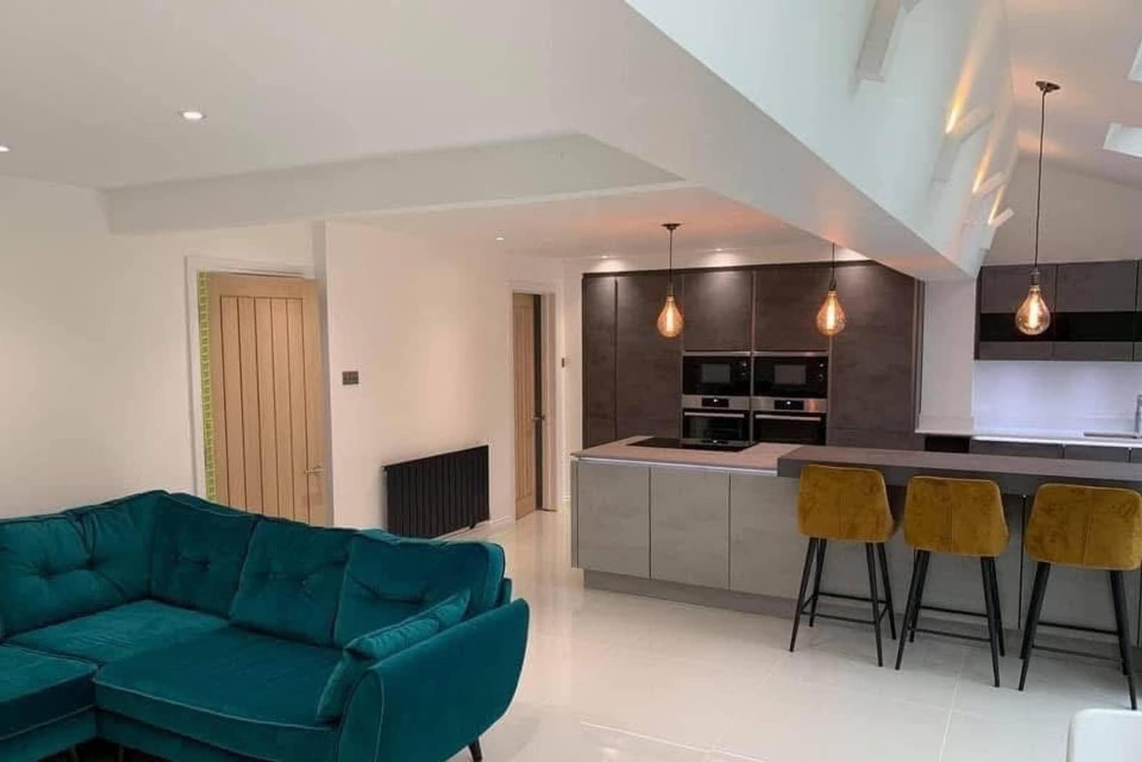 Open-plan kitchen extension with a vaulted ceiling and roof lights, decorated throughout