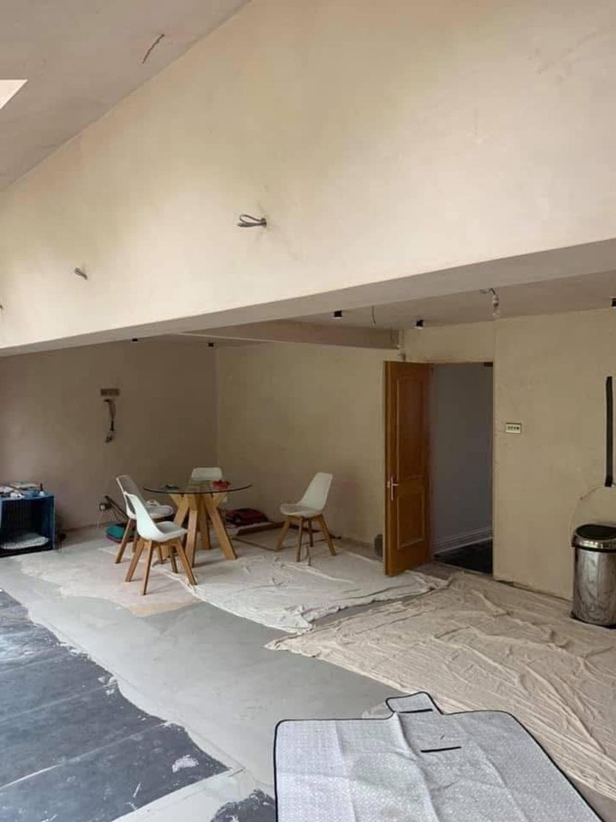 The extension in bare plaster, dust sheets down, before any paint