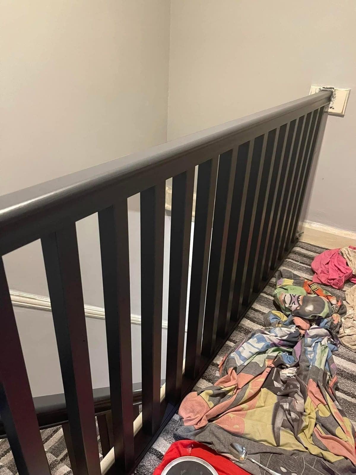 Landing balustrade finished in a dark satin, running along the stairwell